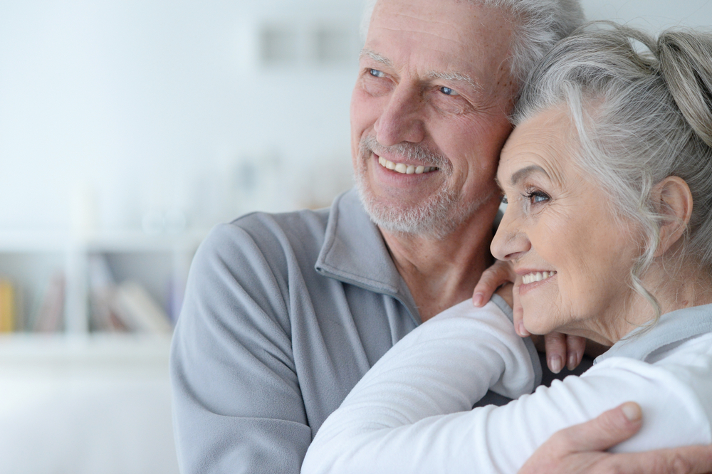 Happy couple smiling in home care agency in Michigan.