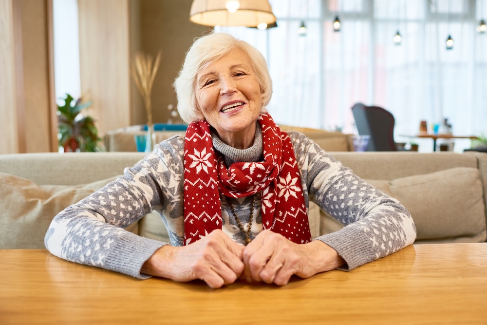 Senior woman at her kitchen table enjoying senior care management service michigan