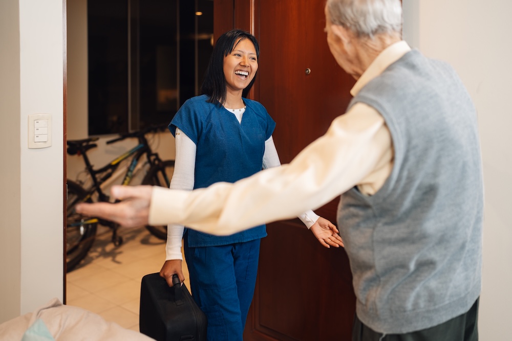 Senior man welcoming his home care agency in Michigan caregiver into his home