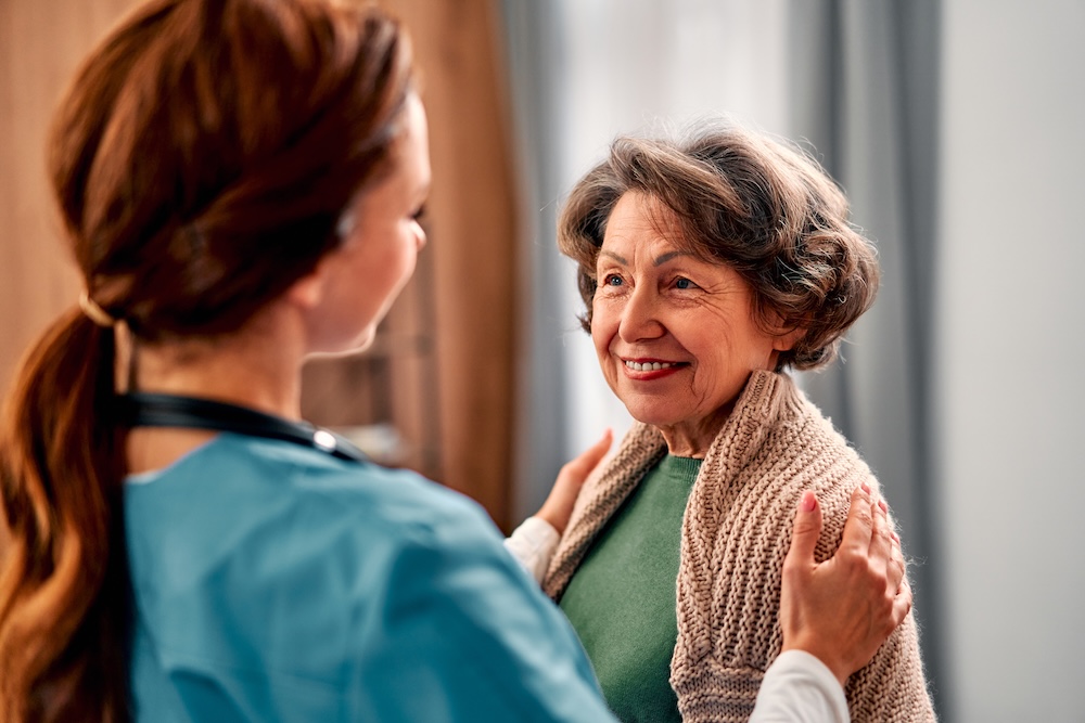 Senior woman with her caregiver from her home care senior living option
